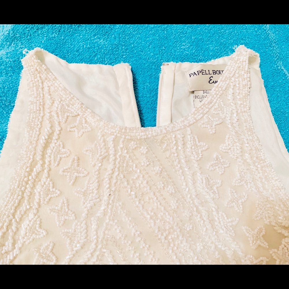 Cream-colored, beaded top.